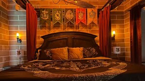 A bedroom with a large bed, red curtains, and wall-mounted lights. - 2817 Storey Lake Kissimmee (Kissimmee)