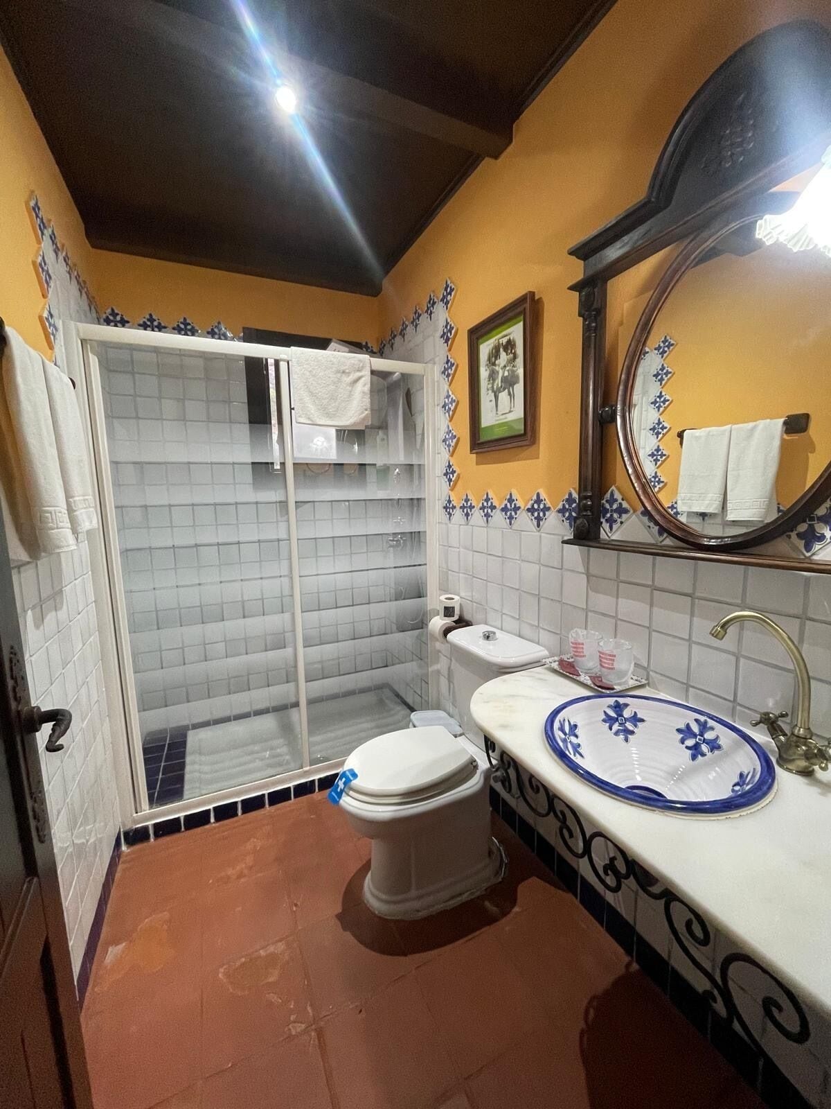 A bathroom with a shower, toilet, and sink.