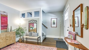 A spacious entryway with a bench, a small table with magazines, and a staircase leading to an upper level. - Easy Access to Pittsburgh: Urban Retreat w/ Deck (Pittsburgh)