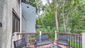 A deck with a table and chairs, surrounded by a railing, overlooking a wooded area. - Easy Access to Pittsburgh: Urban Retreat w/ Deck (Pittsburgh)