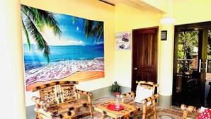 A room with a beach mural, bamboo furniture, and a patterned floor. - Chateau La Princesa with lovely garden & bar "family friendly villa" (Puerto Princesa City)