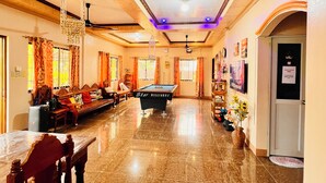 A spacious lobby with a billiards table, seating area, and a reception desk. - Chateau La Princesa with lovely garden & bar "family friendly villa" (Puerto Princesa City)