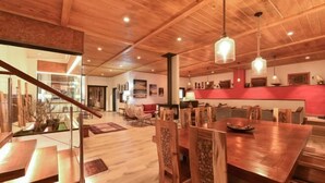 A spacious dining area with wooden furniture and pendant lighting. - Finca la Casona de Abajo Arucas (Arucas)