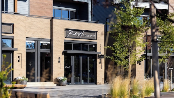 A building with a sign reading 'Pete's Cork in It' and a large glass entrance.