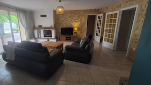 A living room with a fireplace, a television, and a sofa.