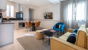 Un appartement moderne comprenant une cuisine, un coin repas et un salon.