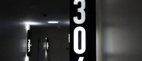 A hallway with a number sign indicating room 306.