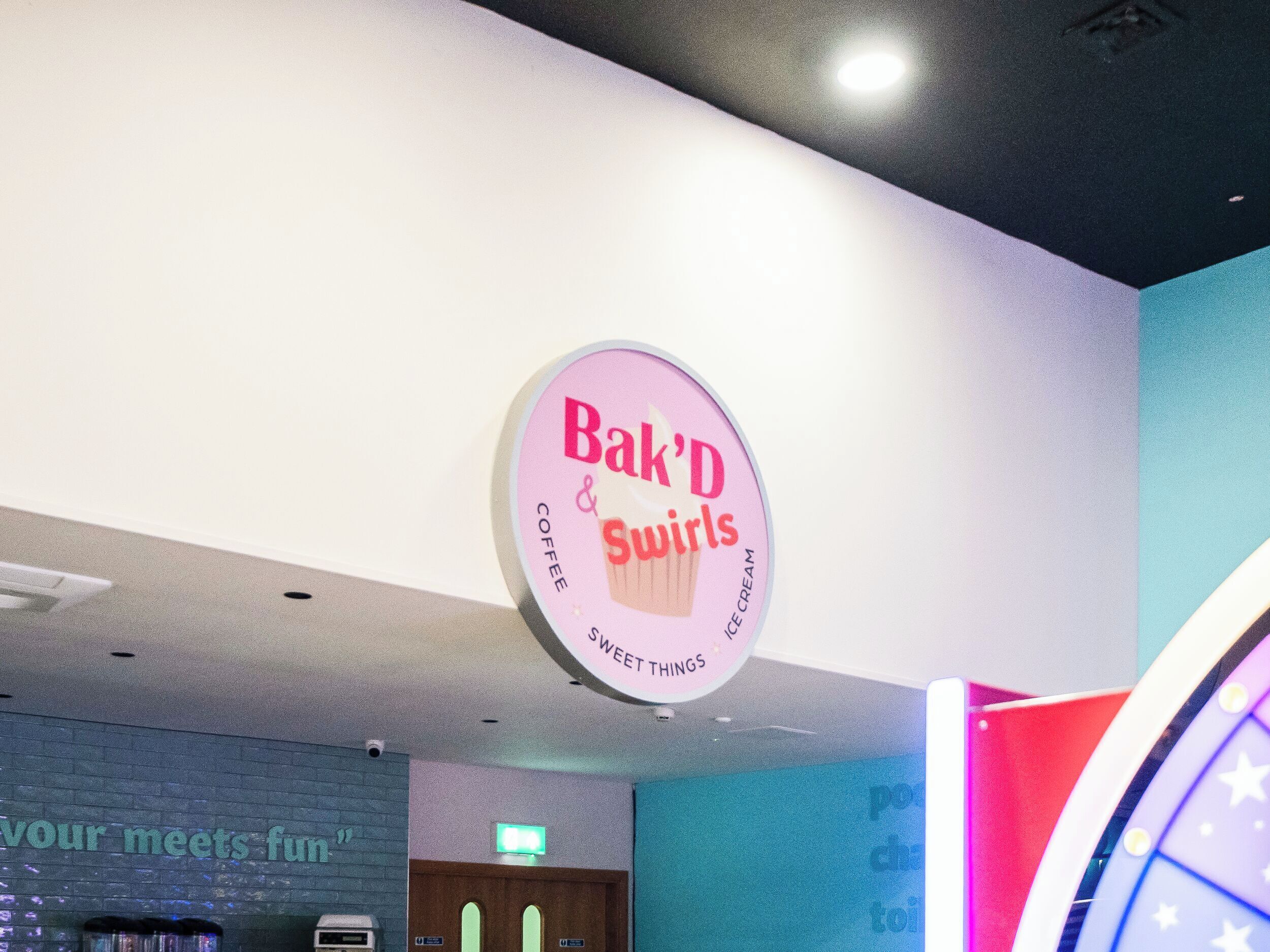 A sign for 'Bak'd Swirls' coffee and ice cream.