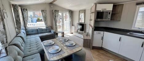 A compact living space with a dining area, kitchenette, and seating.