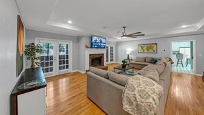 A living room with a fireplace, a sofa, a coffee table, and a television.