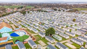 A large caravan park with rows of caravans, a swimming pool, and a tennis court. - The Lookout - Hayling Island (Hayling Island)