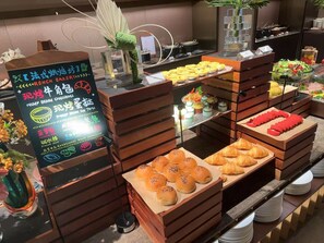 A buffet with various baked goods and a signboard with menu options. -  Crystal Orange Shanghai Changfeng  (Shanghai)