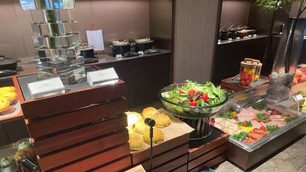A buffet setup with various food items, including a salad, meats, and pastries. -  Crystal Orange Shanghai Changfeng  (Shanghai)