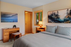 A bedroom with a bed, a desk with a chair, a lamp, and two paintings on the walls. - Spacious home with mountain and valley views, seconds to Deep Creek trailhead (Livingston)