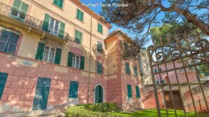 A historic building with multiple windows and a gated entrance. - Music of the Sea- Monterosso (Monterosso al Mare)