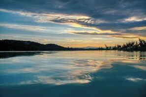 Overlooking a serene lake with a bridge spanning the horizon, this peaceful setting offers a tranquil escape.