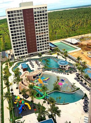 A resort with multiple swimming pools, a water park, and a large building with a modern design. - SaltBeach - Salinas Premium Resort (Salinópolis)