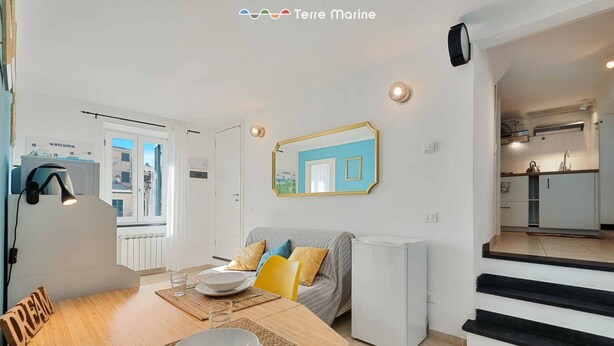 A compact living space with a dining area, kitchenette, and a view of the outside. - The Echo in the Rock, Welcome Way (Vernazza)