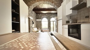 A kitchen with stone walls, a wooden countertop, and a built-in oven. - Blue Stone, Marine Lands (Corniglia)
