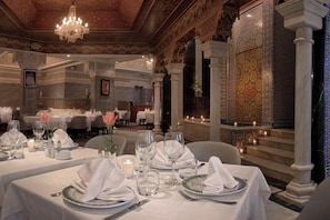 An elegantly set dining area with tables, candles, and a chandelier. - Val D Anfa Casablanca (Casablanca)
