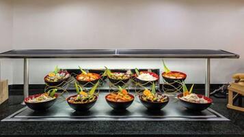 A buffet setup with various dishes on a counter.