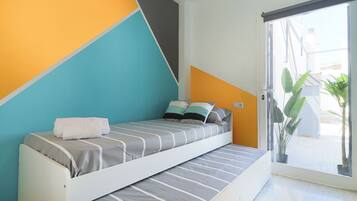 Un dormitorio moderno con una cama, un ventanal y vistas al exterior.