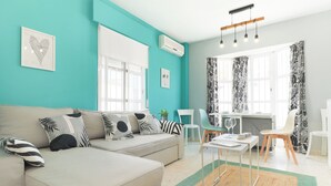 Una sala de estar moderna con un sofá, una mesa de comedor y una zona de cocina.