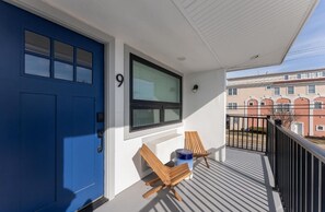 Enjoy the balcony with a comfortable seating area and storage.