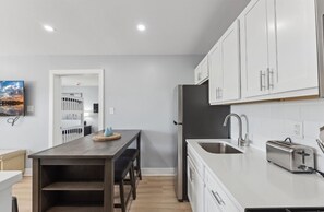 Enjoy meals in the kitchen with a dining area and balcony view.