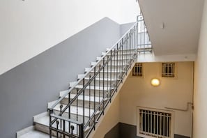 A staircase with metal railings leading to an upper floor.