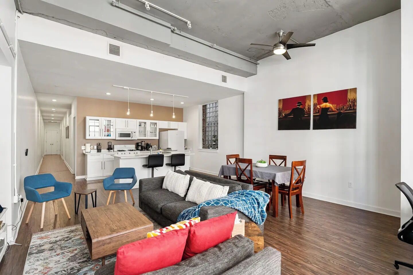 A modern apartment with a living area, dining space, and kitchen.