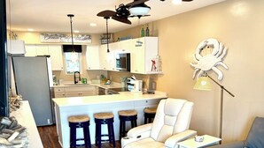 A modern living space with a kitchen, dining area, and seating area. - Charming Canal Water View Townhome with Outdoor Pool, WiFi & AC in Ocean City (Ocean City)