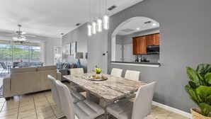 A modern kitchen with a marble countertop, white cabinetry, and a built-in oven. - Trafalgar Resort Community Pool and Gym, Private Pool! (Kissimmee)