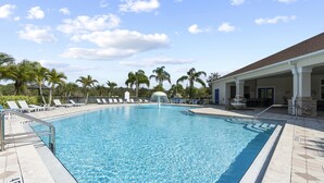 A clear blue swimming pool with lounge chairs and palm trees in the background. - Trafalgar Resort Community Pool and Gym, Private Pool! (Kissimmee)