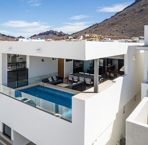 A modern building with a rooftop pool, outdoor seating area, and a view of the surrounding landscape. - SAILOR'S HOUSE IN SAN CARLOS SONORA, MARINA REAL (Son.)
