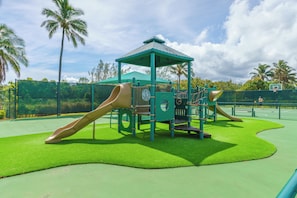 A playground with slides and a shelter.