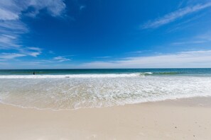 A beach with clear skies and calm waves.