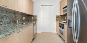 Kitchen features a double door entrance, oven, and stainless steel appliances.