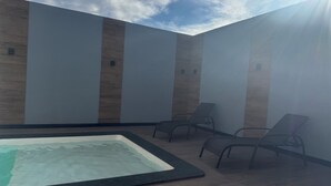 A spa area with a hot tub and seating. - Complete House for Rest (Pedro Leopoldo)