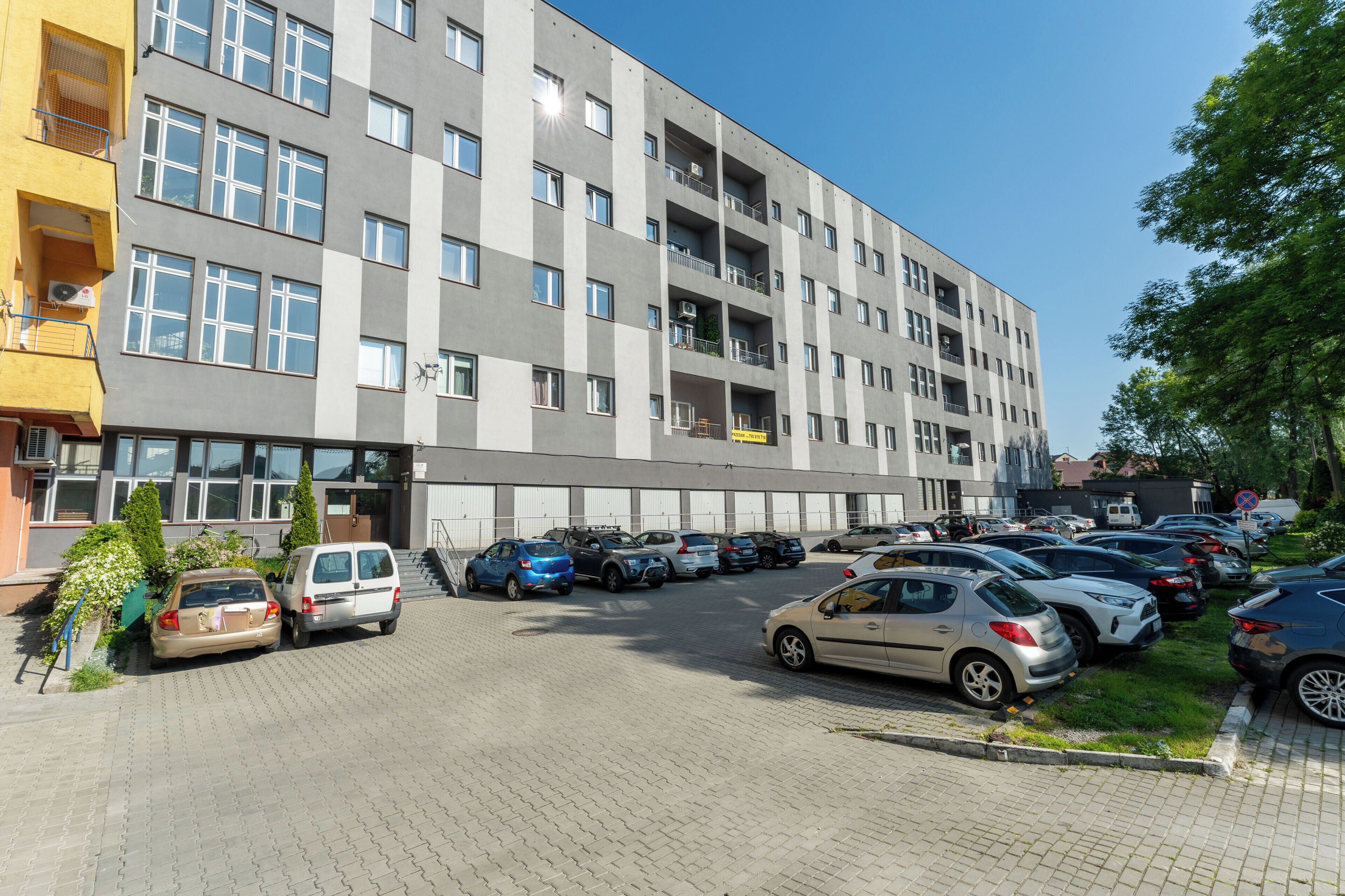 A multi-story parking garage with several cars parked.