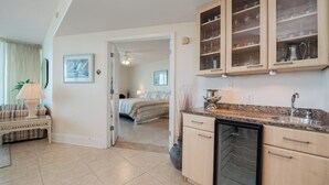 A modern kitchen with wooden cabinets, a built-in dishwasher, and a countertop with a sink.