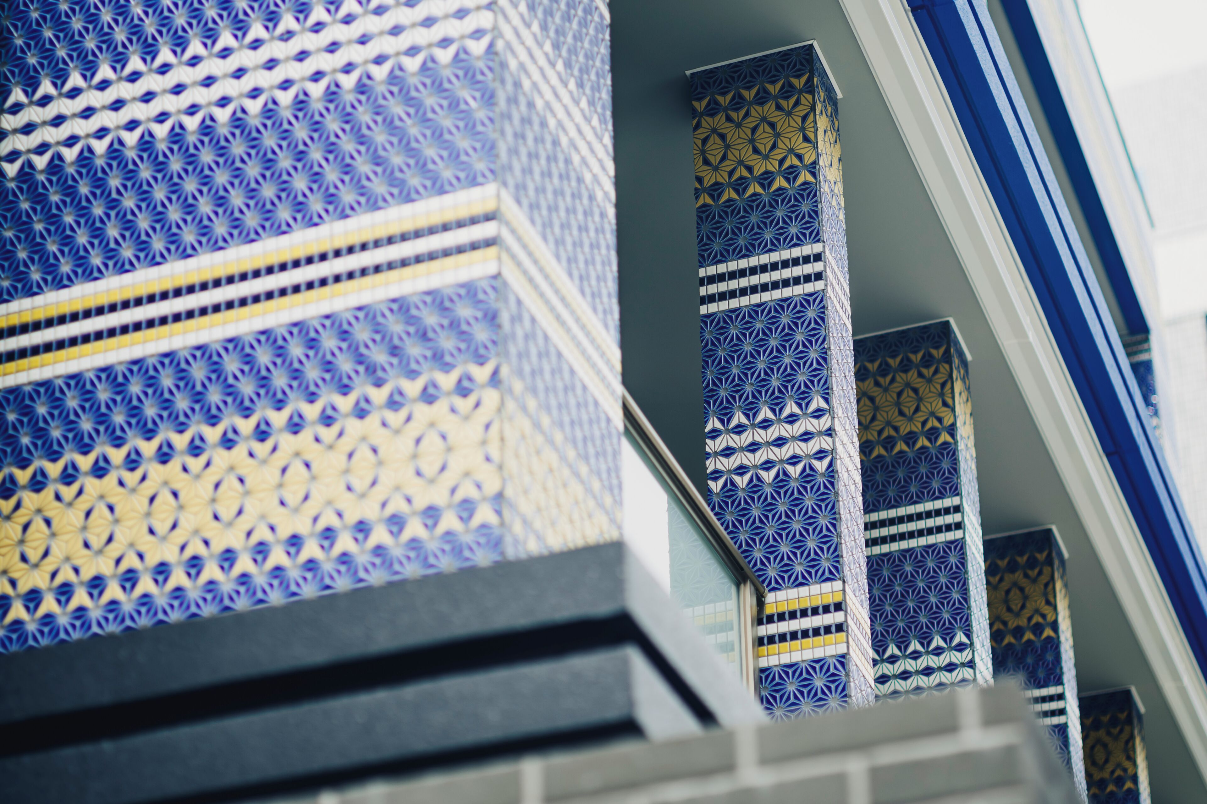 A staircase with blue and yellow patterned tiles.