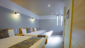 A hotel room with two beds, a carpeted floor, and a wooden door. - GRANDBASESUMIYOSHI (Fukuoka)