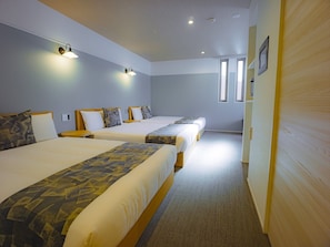 A hotel room with two beds, a carpeted floor, and a wooden door. - GRANDBASESUMIYOSHI (Fukuoka)