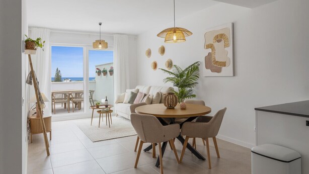 A modern living room with a round dining table, a sofa, and a balcony with a view. - Casa de los amigos Sea View Estepona (Málaga)