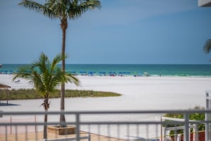 A beach with white sand, palm trees, and a clear blue sky. - Siesta Key Beachfront - 2BR Condo w/ Pools & Views (Siesta Key)