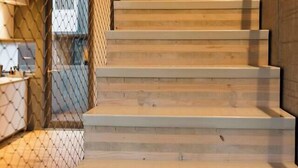 A staircase with wooden steps and a metal railing, leading to an upper level. - Spacious 2BR Oasis in Central Wellington w Terrace (Auckland)