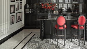 A modern kitchen with dark cabinetry, a marble countertop, and a central island with red chairs. - Memory Villa 3-bedrooms 1' walking to the beach, Ha Long bay (Thành phố Hạ Long)
