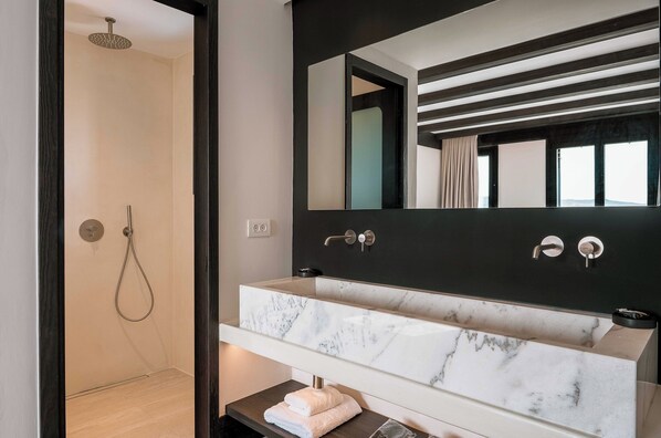 A modern bathroom with a marble sink, a large mirror, and a shower. - Noir Mykonos (Mykonos)