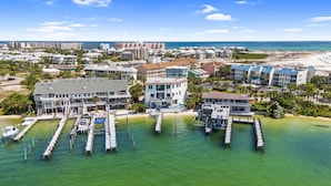 A coastal hotel with multiple buildings, a marina with docked boats, and a beach in the background. - ✨ Maritime Escape | Located on the Destin Harbor | Private Pool + Dock | FREE Parasailing (Destin)